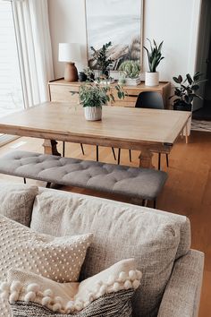 a living room filled with furniture and a wooden table