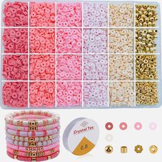 the beads and rings are arranged in an organized box with gold, pink, and white colors