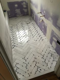 a bathroom that is being remodeled with purple and white paint on the walls, tile floors and floor