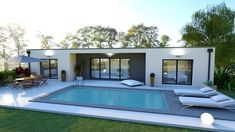 a large swimming pool in front of a house with lounge chairs and tables around it