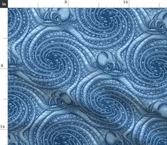 an image of a blue fabric with swirls and bubbles in the center, on a ruler