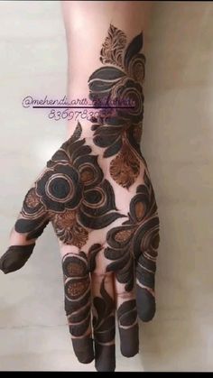 the hand is decorated with henna and flowers