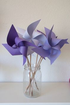 purple and white paper flowers in a mason jar