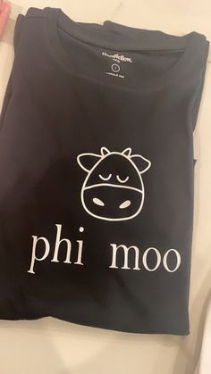 a black shirt with the word phi moo printed on it and a cow's head