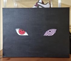 a pair of eyes are painted on a black canvas to look like they're looking at something