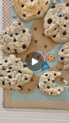 cookies are arranged in the shape of characters on a bulletin board with eyes and noses