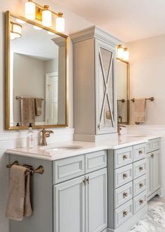 a large bathroom with two sinks and mirrors