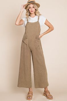 Our best-selling "Pink-ing of You" Overalls is back in more colors!This mineral-washed jumpsuit features a breathable gauze material, square neckline, front pockets, and a relaxed wide-leg fit. Pair it with one of our Basic Tanks or layer with a graphic tee!Each piece goes through a unique mineral-wash process to ensure a one-of-a-kind look with luxurious "lived in" feel for all-day comfort. Model is 5'10" and wearing a small. Material: 100% CottonLength: 54.5" The shoulder straps feature two bu Rodeo Shirts, Jeans Look, Flowy Design, Classy Chic, Taupe Color, Long Shorts, Women Clothing Boutique, Chic Woman, White Tee