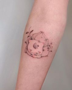 a small cat tattoo on the arm