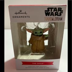 a star wars baby yoda doll in a box