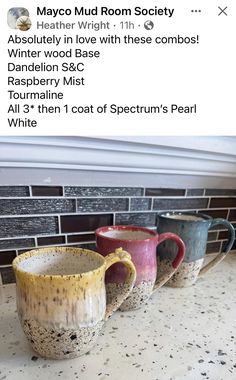 three coffee mugs sitting on top of a counter