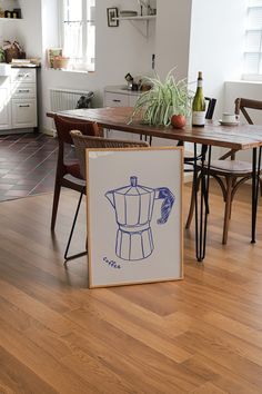 a table and chairs in a room with wood flooring next to a painting on the wall