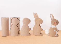 three cardboard rabbits sitting next to each other