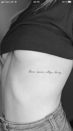 a woman's stomach with the words love never stops here written in cursive font