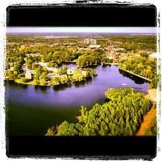 an aerial view of a lake surrounded by trees