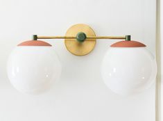 two light fixtures mounted on a white wall