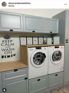 a washer and dryer in a room with gray cabinets on either side of the washer and dryer