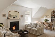 a living room filled with furniture and a fire place