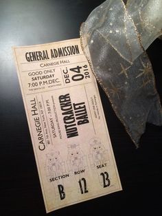 an old concert ticket sitting on top of a table next to a piece of cloth