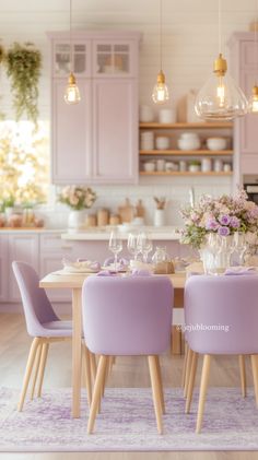 a dining room table with purple chairs and flowers