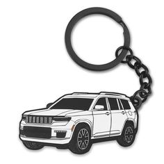 a black and white jeep keychain with the image of a suv on it