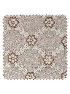 a brown and white rug with flowers on the bottom, in front of a white background