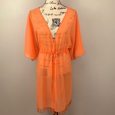 Nwt Ymi Swimwear Swim Cover Up Wrap Shawl Lightweight Sheer Tangerine With Lace / Tassel Trim Sheer/See-Through Cover-Up Open V Neckline Front Tie Waist Closure 100% Polyester Woman’s Size 3x Flat Lay Measurements (Drawstring Open) 25” Pit To Pit 36” Shoulder To Hem 1417/Kuw Casual V-neck Cover-up With Tassels, Spring Festival Cover-up With Tie Waist, Summer V-neck Cover-up With Drawstring, V-neck Drawstring Cover-up For Vacation, Spring Beach Cover-up Swimwear With Tassels, Casual Swimwear With Tassels For Vacation, Casual Vacation Swimwear With Tassels, Spring Vacation Swimwear With Tassels, Spring Beachwear With Tassels