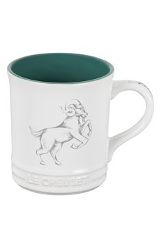 Get a star-sign start to your day with this beautifully illustrated mug crafted from hearty stoneware to help keep your beverage at the perfect temperature. 4.7" x 3.9" x 5.2" 0.8 lb. Holds 14 oz. Stoneware Dishwasher safe Imported Mug Crafts, Stoneware Mugs, Le Creuset, Star Sign, Star Signs, Mug Cup, White Green, Stoneware, Dishwasher Safe