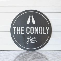 a sign that says the connoly bar on it's side wall next to a counter