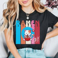 Introducing our adorable Kawaii Cat Ramen t-shirt, perfect for anyone who loves cute designs. Made from high-quality materials, this comfortable and stylish t-shirt features a delightful design of a cute cat enjoying a bowl of ramen noodles. Our Kawaii Cat Ramen t-shirt makes a great gift for cat lovers and ramen enthusiasts alike. Whether you wear it out and about or cozy up at home, this t-shirt is sure to bring a smile to your face. Order now and add a touch of cuteness to your wardrobe! Production Time:  2-5 business days (usually 2-3 days) Materials: ~Bella and Canvas 3001 Unisex Tshirt  ~100% Airlume combed and ringspun cotton (heather tshirts are 50% cotton/50% polyester) ~Light fabric (4.2 oz/yd² (142 g/m Sizing: ~Runs true to size ~Please refer to the size chart in the photos to f Kawaii Short Sleeve Top With Cat Design, Cat Eating Ramen Drawing, Ramen Cat Illustration, Kawaii Cotton T-shirt With Anime Print, Cute Black T-shirt With Cat Design, Ramen T Shirt, Cute Short Sleeve T-shirt With Cat Print, Japanese Shirt, Kawaii Shirts