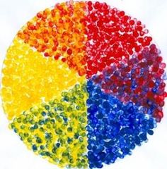 there is a circle made up of many different colored beads on the white background with words written below it