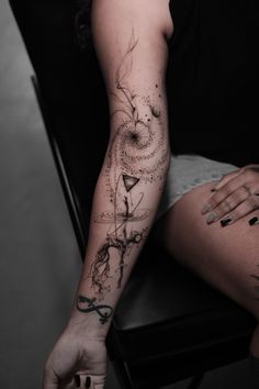 a woman's arm with tattoos on it