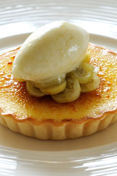 a pastry with bananas and cream on top