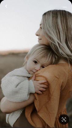 a woman holding a baby in her arms