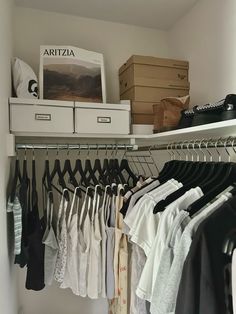 an organized closet with clothes and boxes