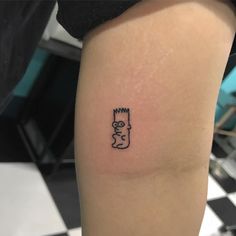 a small simpsons tattoo on the right thigh, with an outline of homer from the simpsons