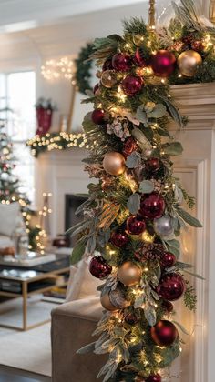 a christmas garland with ornaments hanging from it's side in front of a fireplace