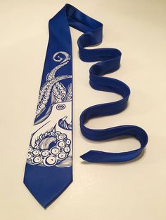 "High quality necktie. Great material. Very durable. 3.2'' at the widest point, 58\" long from tip to tip.  Adult necktie.  If you need something added or changed feel free to message me.  Custom designs are welcome, I will do my best to make it on a tie, no set up fee for custom graphic. You pay only if you approve the final look on the tie.   I try to ship the next business with USPS First Class Shipping which takes 3-5 days to arrive. If you order more then 3 ties I will ship Priority Mail 2-3 days to arrive.  Enjoy browsing my store for the perfect necktie." Adjustable Blue Ties For Father's Day, Adjustable Standard Tie For Gift, Blue Necktie, Cool Ties, Silver Logo, Tie Accessories, Suit And Tie, Look On, Different Fabrics