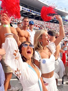 a group of people standing around each other at a football game