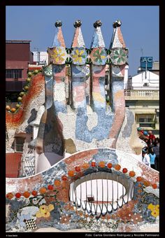 an elaborately designed building with many windows and decorations on the roof, in front of a blue sky