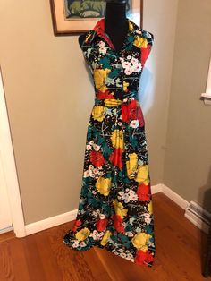 1960s black floral print halter dress: This knit dress is in a bold large print. The background color is black and it has a yellow, red, green and white floral motif. It is collared and has front buttons and a back zipper. The bodice is fitted and the skirt flares and flows. It is sashed at the waist. Measurements: Bust 36 in. Waist 26 in Hips 38-40 in. Length 57 in. Vintage Black Maxi Dress With Floral Print, Black Retro Maxi Dress For Spring, Retro Black Maxi Dress, Printed Halter Dress, Late 1960s, Black Floral Print, Dress Clothes For Women, Green And White, Large Prints