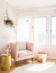 a living room filled with furniture and a potted plant on the side of the wall