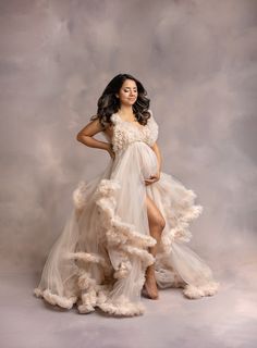 a woman in a white dress posing for a photo