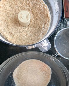 two pans filled with food sitting on top of a counter next to each other