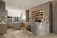 a modern kitchen with marble counter tops and bar stools