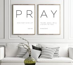 two posters with the words pray and not give up on them in a living room