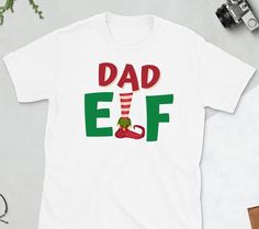 a t - shirt with the words dad elf on it