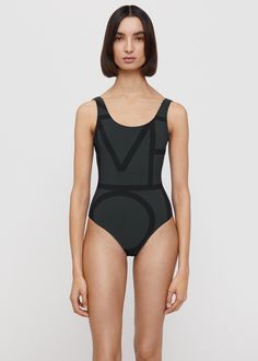 Totême swimsuit in a recycled polyamide fabric with a four-way stretch and a SPF construction. It’s designed for a close fit and shaped to a classic silhouette with a deep u-back and high-cut legs. Pack with Monogram jacquard beach towel on your next beach getaway. Black Second-skin Bodysuit For Poolside, Modern Swimwear For Summer, Black Minimal Stretch Bodysuit For Swimming, Modern Summer Swimwear, Summer Black Polyamide Bodysuit, Modern Black Swimwear For Pool, Black Polyamide Bodysuit For Summer, Black Second-skin Bodysuit For Pool, Modern Fitted Black Swimwear