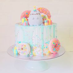 a birthday cake decorated with donuts and sprinkles