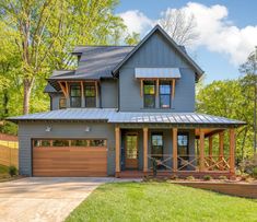 a house with a metal roof and two car garages